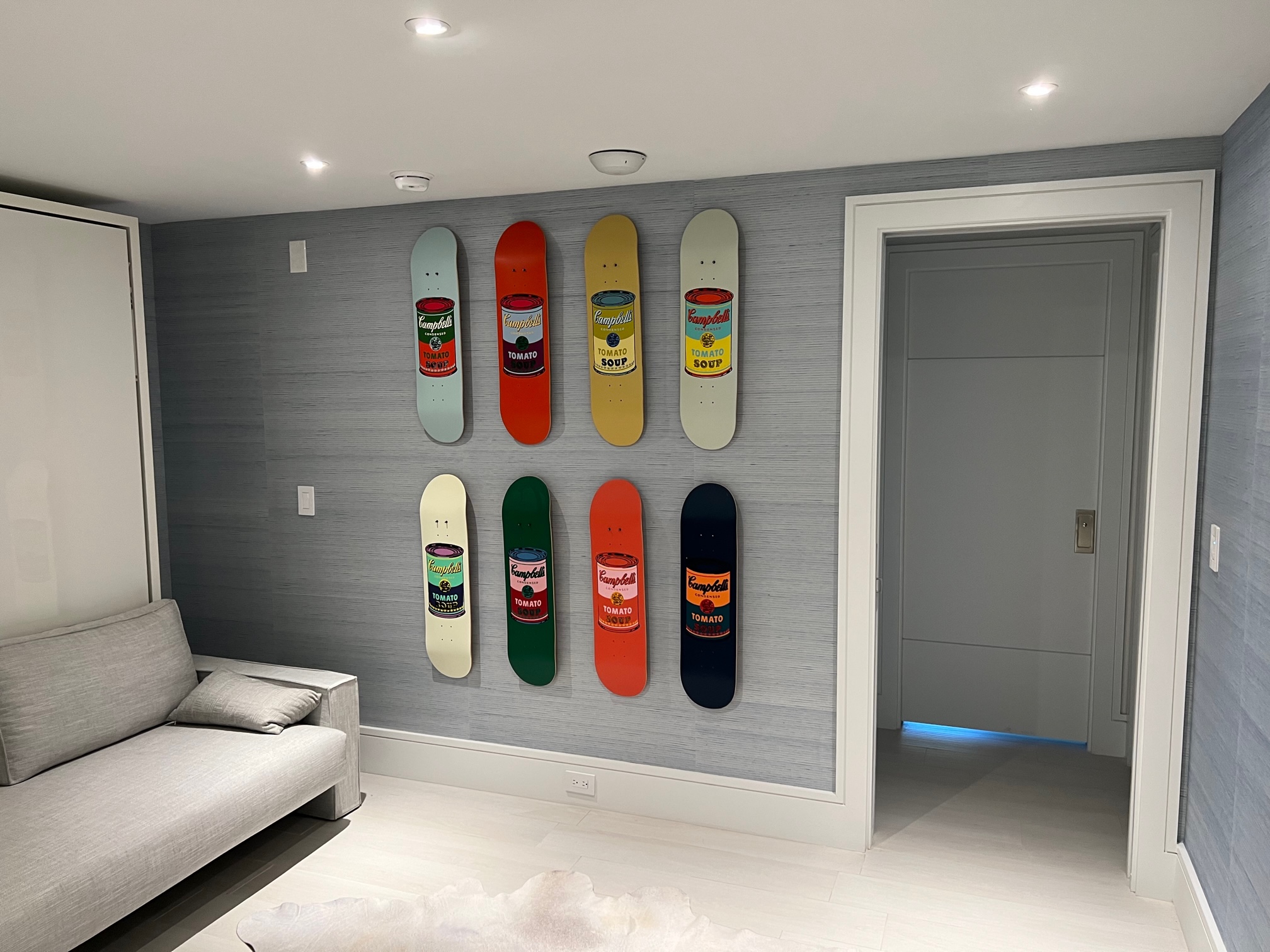 Primary bedroom with blue grassweave wallpaper installation